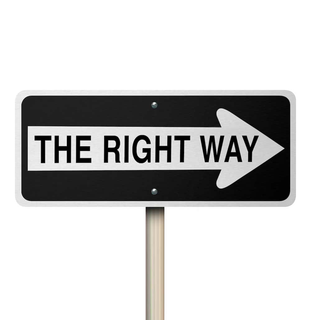 a sign on a pole with an arrow and text saying 'the right way'