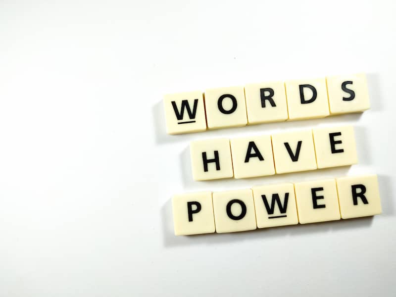 Scrabble letters spelling out 'Words have power'.