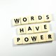 Scrabble letters spelling out 'Words have power'